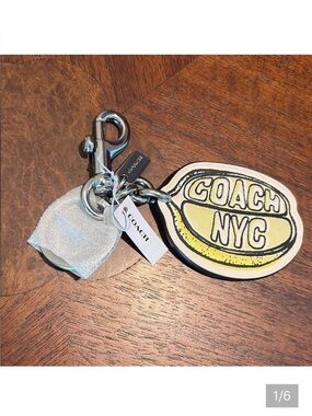 Coach  lemon bag charm  leather
Yellow/cream/white  inscribed “ Coach NYC”  NWT